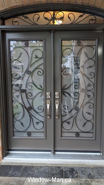 Double front door. Round top transom. Rochester wrought iron glass inserts. color. Windswept Smoke